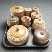A collection of treen lidded storage jars and pots.