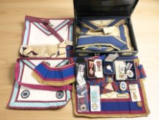 A collection of Masonic regalia including various medals, briefcase, satchels, etc.