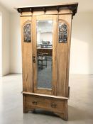 An Art Nouveau mirrored door wardrobe with inset embossed copper panels, 100 cm x 52 cm x 193 cm.