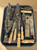 A group of antique irons, woodworking tools, oil cans, etc.