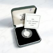 A Royal Mint 1990 silver piedfort five pence coin, with certificate of authenticity.