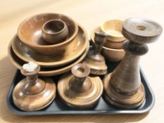 A group of turned wooden treen candlesticks, fruit bowls, etc.