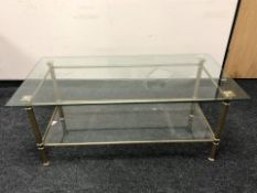 A rectangular brass and glass two tier coffee table, 121 cm x 60 cm x 51 cm.