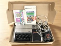 A Texas Instruments TI-99/4A computer, with cartridges, leads, etc.