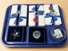 A collection of boxed Swarovski crystal paperweights.