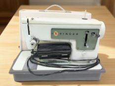A Singer electric sewing machine with lead and pedal.