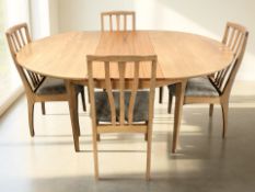 A 20th century oval teak extending dining table with two leaves, extended 168 cm x 123 cm x 77 cm,