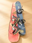 A snowboard in carry bag and a pair of boots.