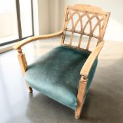 A 1920's oak lattice back low armchair, width 59 cm.