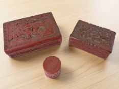 Three Chinese cinnabar lacquer trinket boxes, largest 15 cm wide.