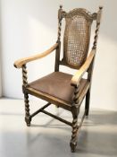 An Edwardian oak barley twist armchair.