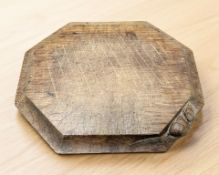 A 20th century Robert 'Mouseman' Thompson of Kilburn oak bread board, with carved mouse signature,