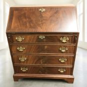 A reproduction mahogany fall front bureau in the George III style, 76 cm x 50 cm x 92 cm.