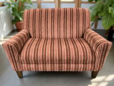 A contemporary two seater settee in striped red upholstery, width 127 cm.