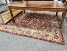 A machine-made rug of Iranian design, 220 cm x 170 cm.