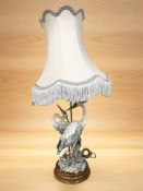 A Capodimonte table lamp in the form of two storks, with shade, height 82 cm overall.
