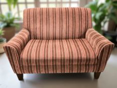 A contemporary two seater settee in striped red upholstery, width 127 cm.