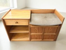 A Nathan teak telephone seat, width 92 cm.