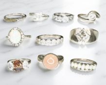 Ten sterling silver rings, each set with synthetic stones.
