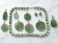 A collection of jade jewellery comprising a pair of cabochon earrings with screw fittings,