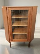 A 20th century glazed Danish teak single door corner cabinet, height 123 cm.