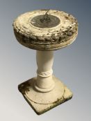 A weathered concrete sun dial, height 68 cm.