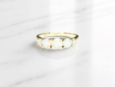 A 9ct yellow gold ring set with five opals, size S. CONDITION REPORT: 2.68g.