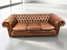 A Chesterfield buttoned leather three seater club settee,
