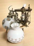 A ceramic and brass light fitting with glass shades