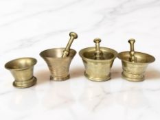 Four 18th / 19th century bronze bell mortars, three with pestles, tallest mortar 9 cm.