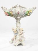 A Sitzendorf encrusted porcelain pedestal comport surmounted by two cherubs,