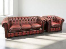 A Chesterfield oxblood buttoned leather three seater club settee, width 185 cm,