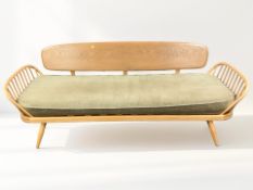 An Ercol light elm Model 355 three seater day bed / settee, length 205 cm.