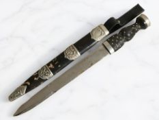 A 20th century Scottish Skein Dhu dirk, with 31 cm etched steel blade, carved wooden studded grip,