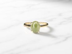 A gold cabochon stone dress ring, stamped 10K,