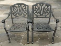 A pair of contemporary stamped metal garden armchairs, width 65 cm.