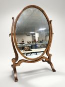A reproduction yew wood oval swing dressing table mirror, height 57 cm.