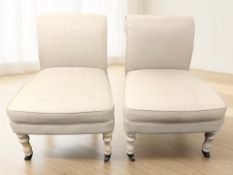 A pair of contemporary low occasional chairs, in oatmeal fabric, width 55 cm.