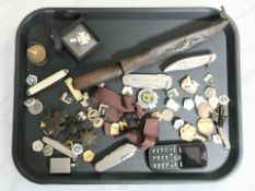 A group of badges, pen knives, awards, mobile telephone, tape measure.