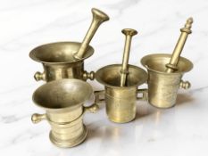 Four 18th / 19th century bronze bell mortars, three with pestles, tallest mortar 15 cm.