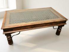 A contemporary hardwood wrought metal and glass topped rectangular coffee table,