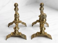 A pair of late Victorian brass fire dogs, height 17 cm.