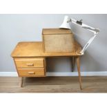 A 20th century teak sewing machinist's two drawer single pedestal desk,