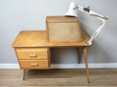 A 20th century teak sewing machinist's two drawer single pedestal desk,