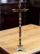 An early 20th century turned beech and cast brass mounted smoker's stand, height 68 cm.