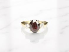 A gold garnet dress ring, stamped 585, size S. CONDITION REPORT: 3.