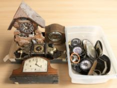 Two boxes containing various clocks and clock parts, height 16 cm.