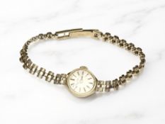 A lady's 9ct gold Bulova wristwatch on 9ct gold integral bracelet CONDITION REPORT: