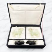 A pair of Chinese carved jadeite horses with carved wooden stands, overall 13cm high,