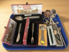 A group of boxed Norwegian pewter cutlery, two pun cushions in the form of lady's shoes,